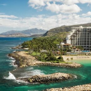 Coastal resort with scenic ocean view, lush mountains.