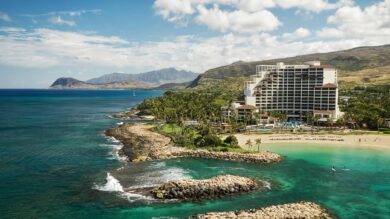Coastal resort with scenic ocean view, lush mountains.