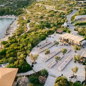 Outdoor wedding venue near the sea with greenery.