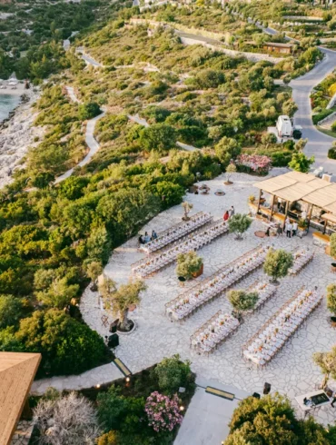 Outdoor wedding venue near the sea with greenery.