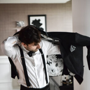 Man putting on floral-lined suit jacket