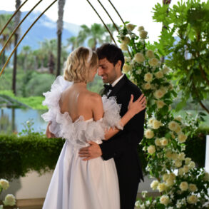 Bride and groom embracing at outdoor wedding