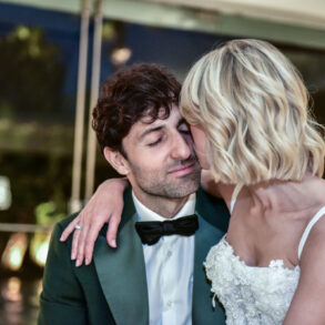Bride and groom embrace on wedding day.