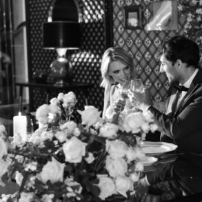 Elegant couple toasting at a candlelit dinner.