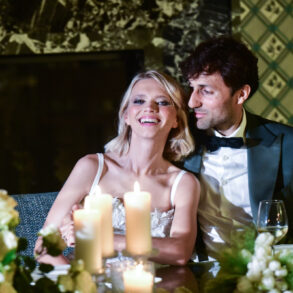 Couple celebrating at a candlelit dinner.