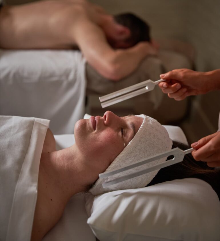 Couple enjoying relaxing spa treatment.