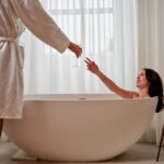 Couple enjoying champagne in a luxurious bathtub.