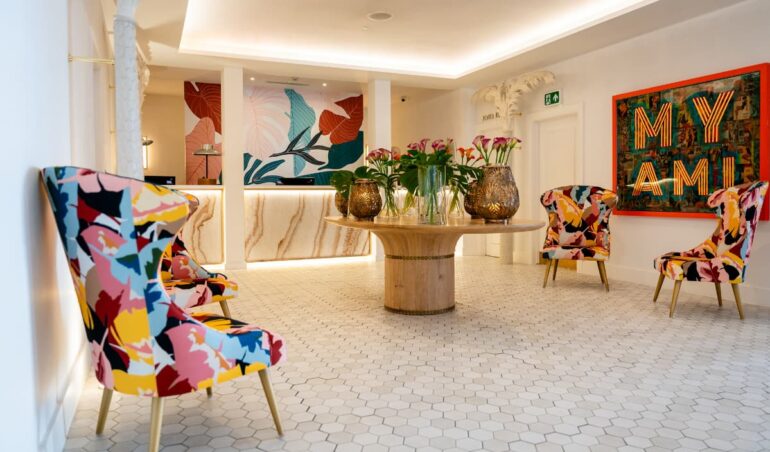 Colourful hotel lobby with modern decor and chairs.