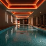 Luxurious indoor swimming pool with modern lighting.