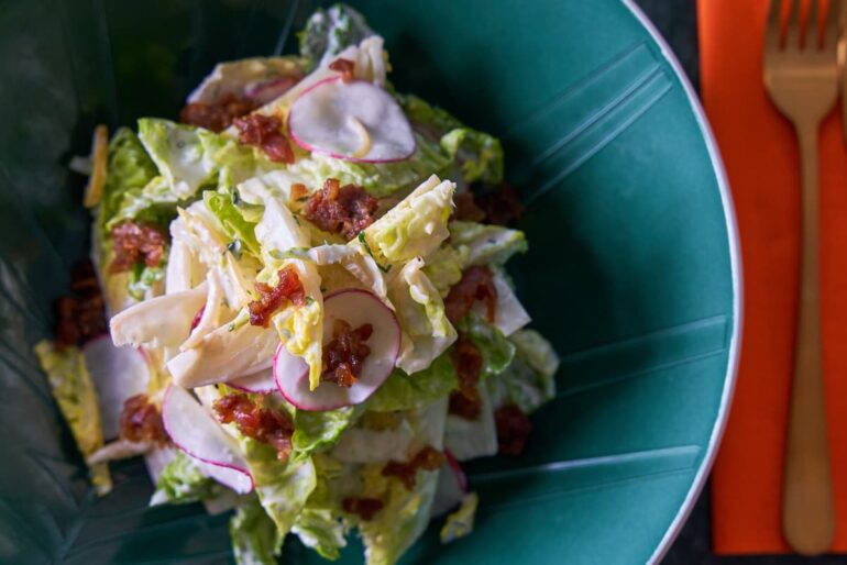 Fresh salad with radishes and crispy bacon.