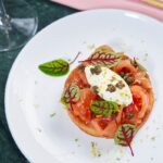 Gourmet dish with salmon and greens on plate.