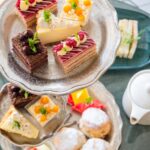 Assorted cakes and scones on a tiered stand.
