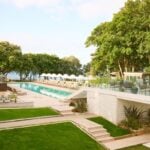 Luxury outdoor pool with green surroundings.
