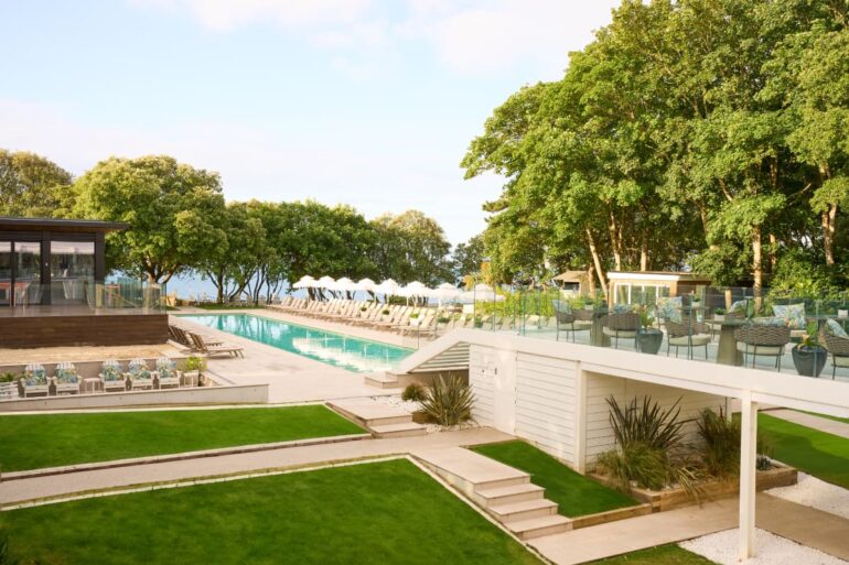 Luxury outdoor pool with green surroundings.
