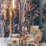 Stylish lounge with palm lamp and patterned chairs.