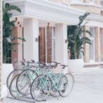Mint bicycles parked outside a building entrance