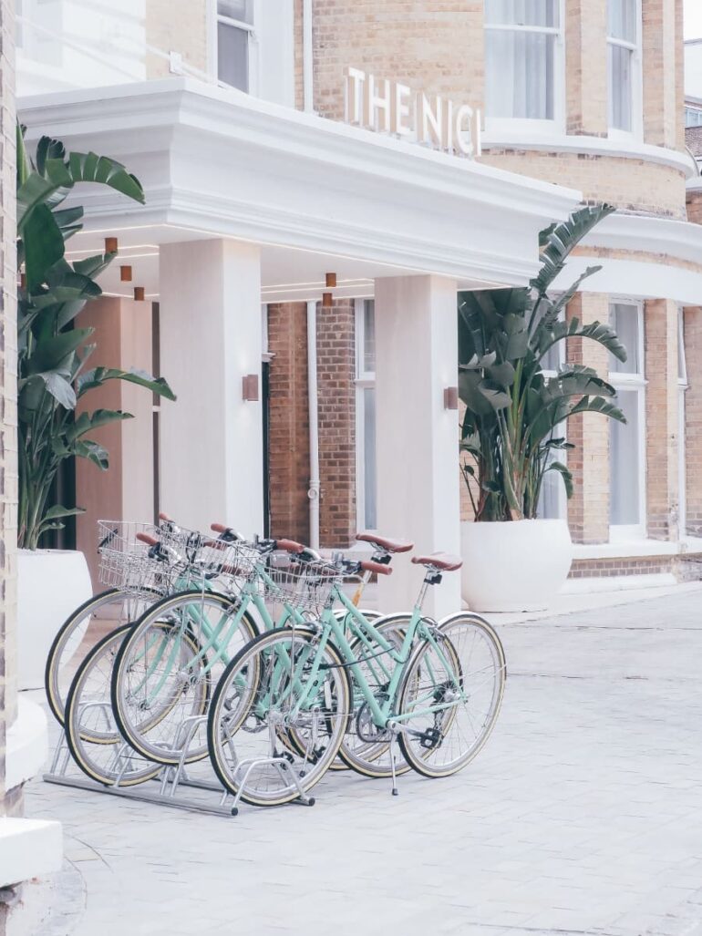 Mint bicycles parked outside a building entrance