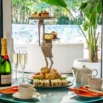 Luxurious afternoon tea with champagne and pastries.