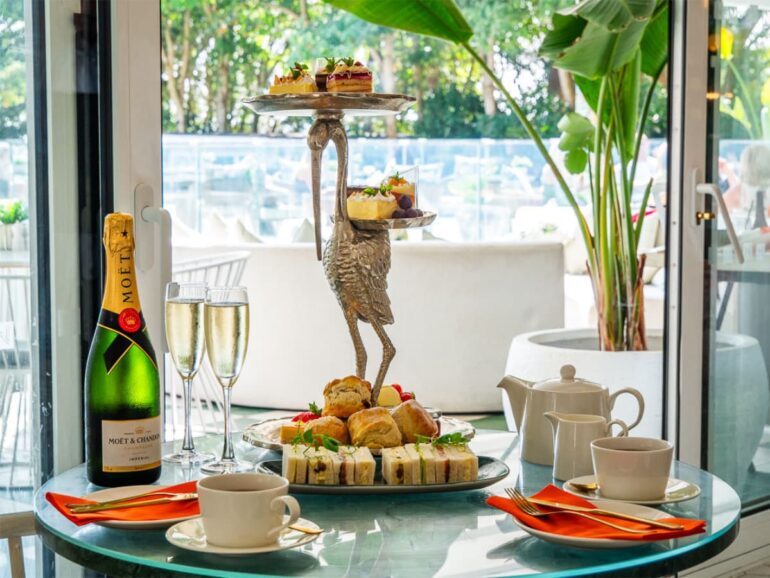 Luxurious afternoon tea with champagne and pastries.