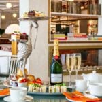 Elegant high tea with champagne and pastries.