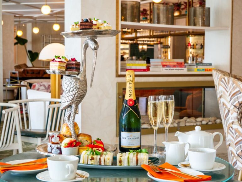 Elegant high tea with champagne and pastries.