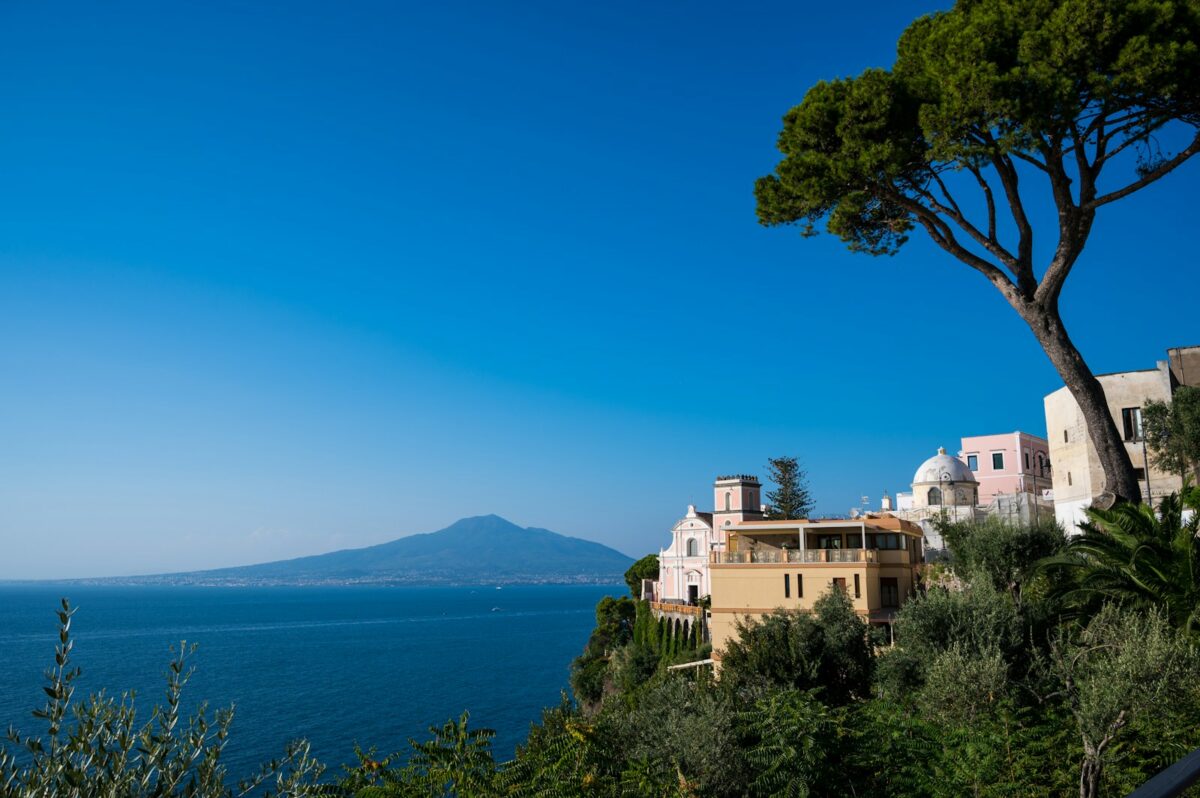 Best Places to Visit in Campania a body of water with buildings and trees around it