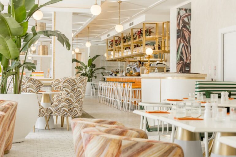 Modern cafe interior with plants and stylish decor.