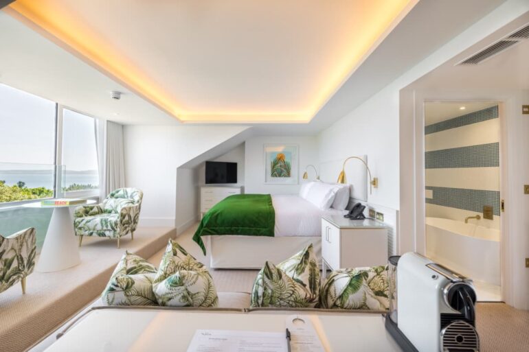 Luxurious hotel room with ocean view and modern amenities.