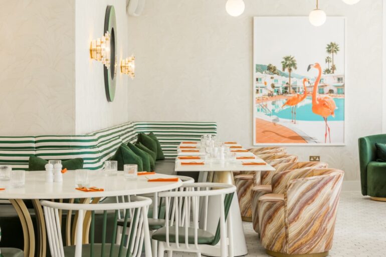 Modern restaurant interior with striped seats and artwork.