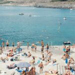 a large group of people are on the beach