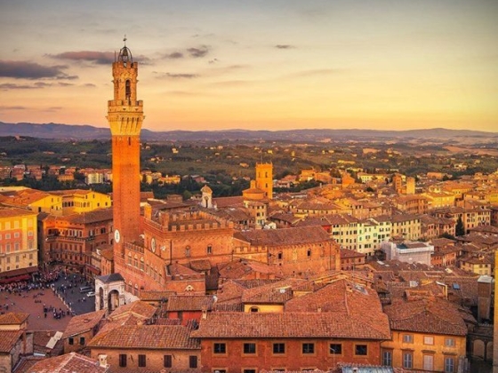 Aerial view of Siena's skyline at sunset.