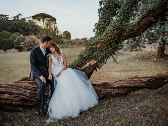 A couple enjoys a moment together in a serene outdoor setting.