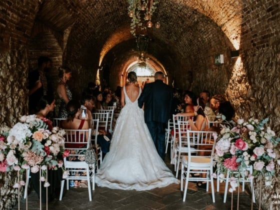 Couple walking down the aisle in an intimate setting.