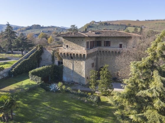 Scenic view of a historic house in a picturesque landscape.