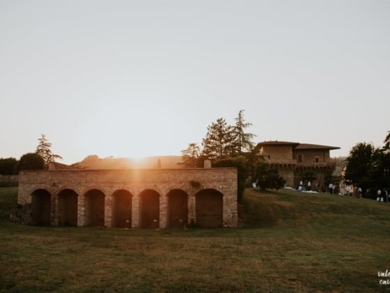 Scenic view of a sunset behind a stone building.