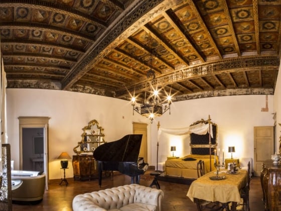 A vintage interior showcasing a grand piano and luxurious decor.