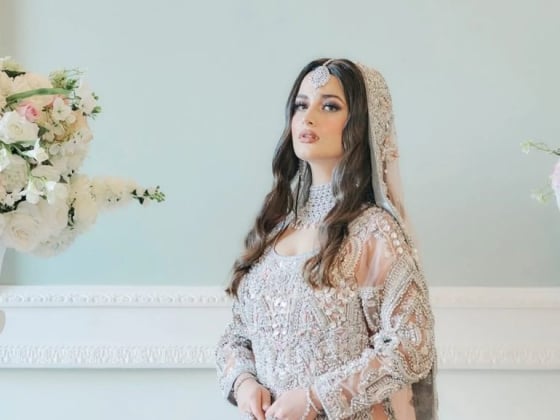 Bride posing elegantly in a decorated setting.