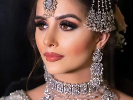 A beautifully adorned woman showcasing traditional jewelry.