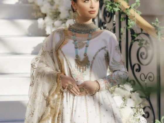 Model showcasing cultural attire among floral decor.