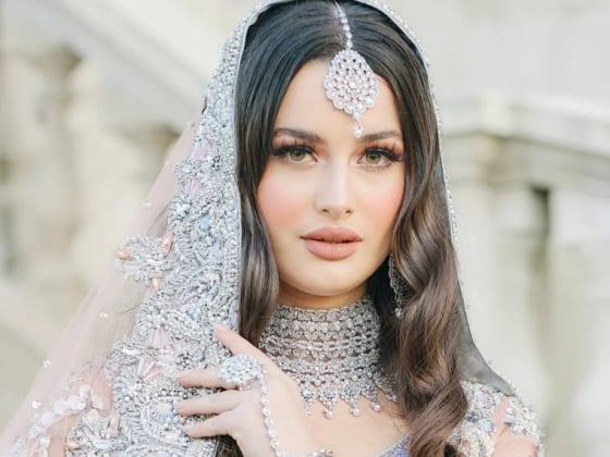 Elegant bridal portrait with detailed attire and accessories.