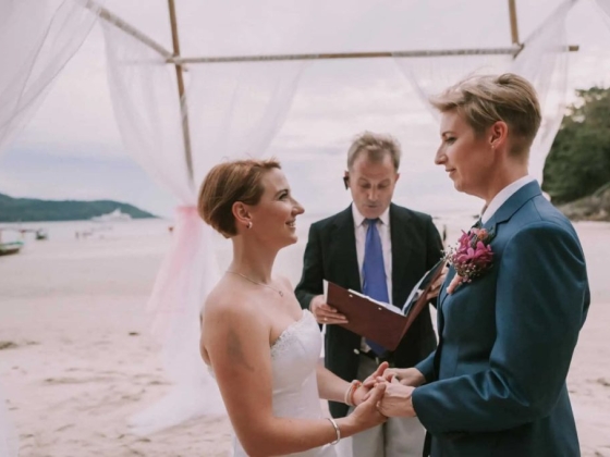 A joyful moment during a beach wedding.