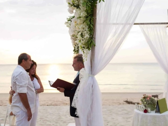 Couple exchanging vows during a romantic beach wedding.