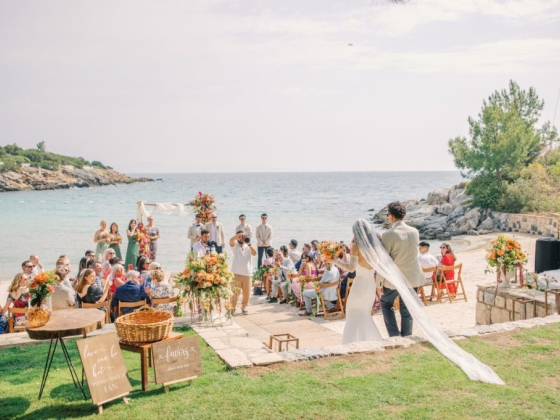 Bride and groom exchange vows by the sea.