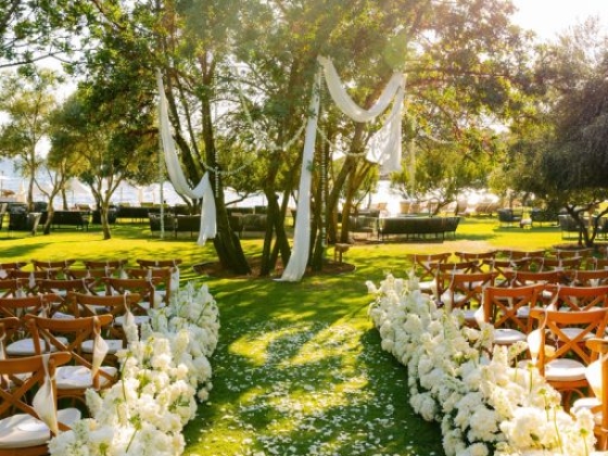 A charming wedding setup with floral arrangements and sunlight.
