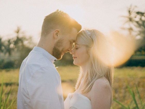 Romantic embrace during golden hour in nature.