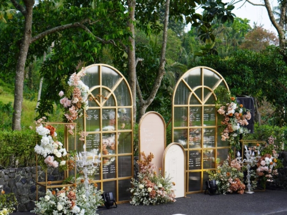 Beautiful wedding setup featuring floral designs and mirrors.