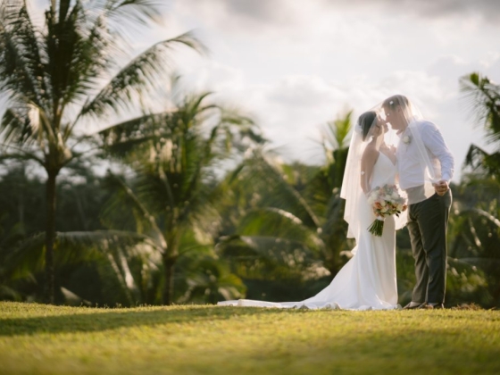 A romantic moment between a couple surrounded by greenery.