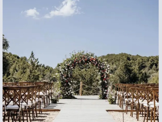 A beautiful outdoor wedding altar surrounded by chairs.