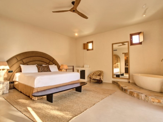 Stylish bedroom featuring a large bed and unique decor.