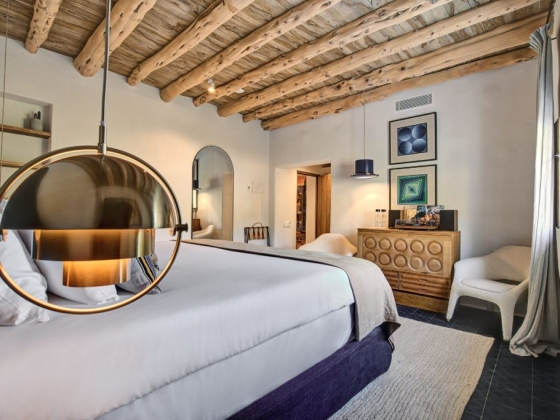 A cozy room featuring a round pendant light and chic furnishings.